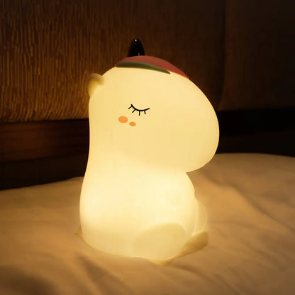 White unicorn night light on a pillow